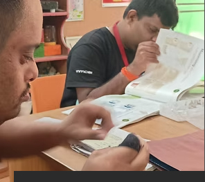 A participant binding a book by hand